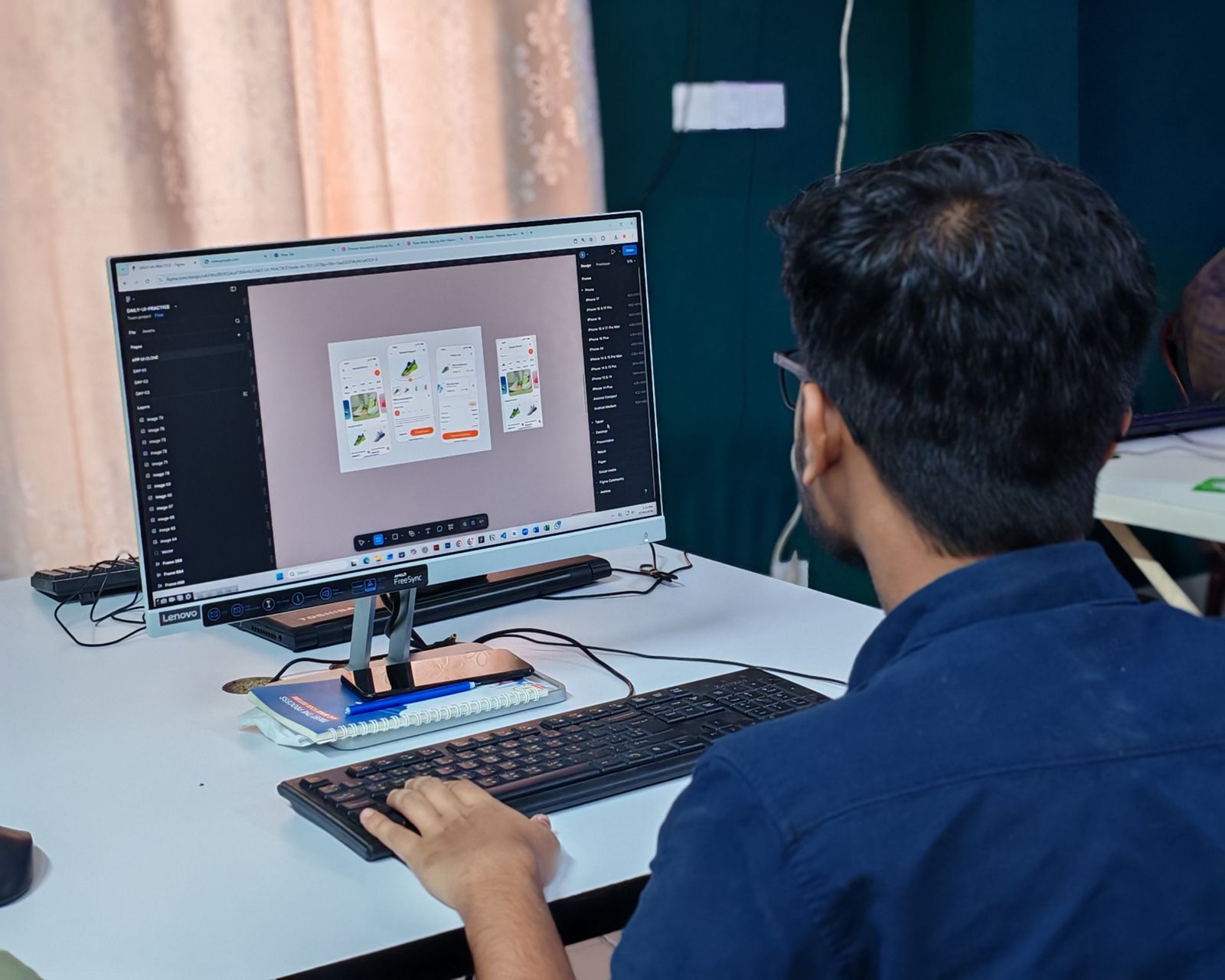 Designer working on mobile app screen layouts in a design tool