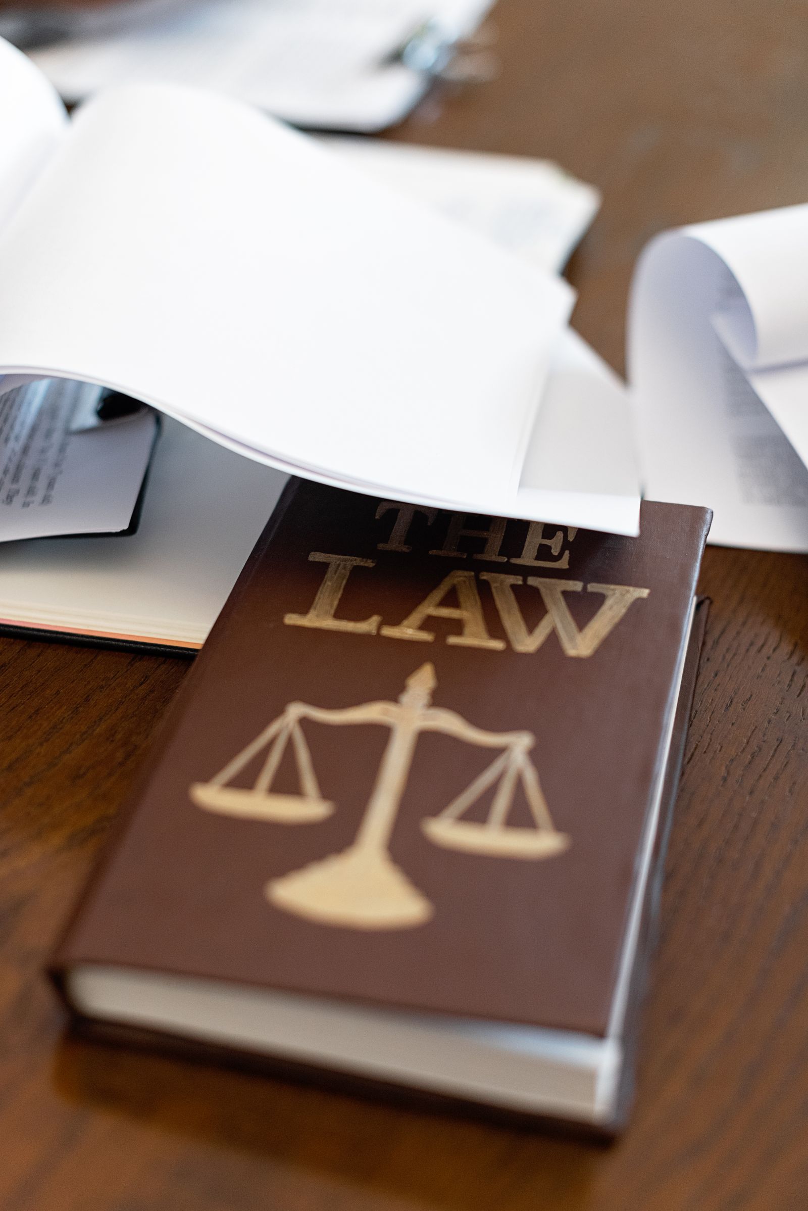 A law book titled The Law with scales of justice on a lawyer's desk in Gorakhpur