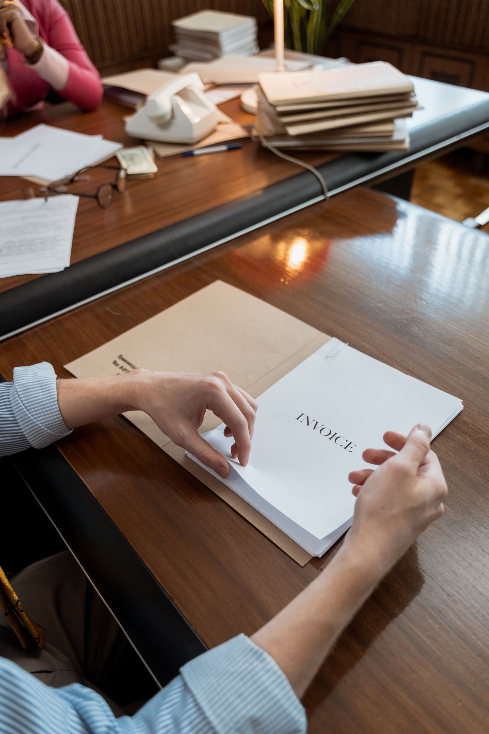 An invoice document being reviewed, representing website project cost and billing